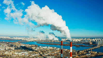 Coal Power Pollution smoking stack. Coal power plant smoking and teaming. Smoke from the pipes in...