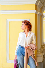 Fashion portrait of a young stylish woman walking down the street.