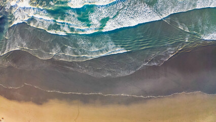 Fototapeta na wymiar Aerial view to ocean waves. Blue water background. ocean breaks on shore. Aerial view to waves in ocean Splashing Waves.