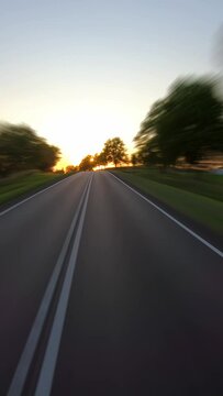 On a rural road to sunset, vertical time-lapse