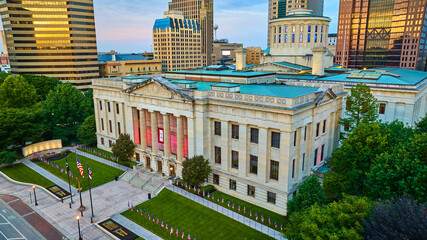 Golden sunrise hitting building windows above Capital Square Foundation Columbus aerial