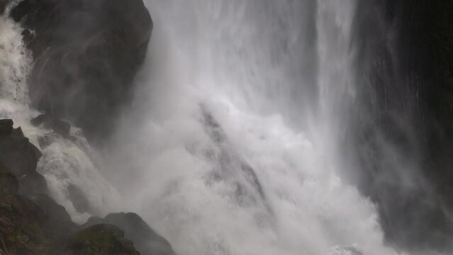 Waterfall in the mountains closeup. Water falls from the rocks high in the mountains. Seerenbach Falls, Betlis, Amden, Walensee. Canton of St. Gallen, Switzerland.