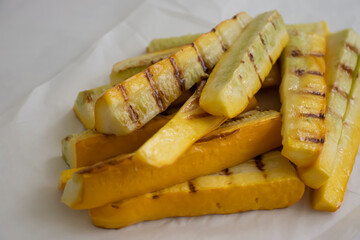 Zucchini slices fried on the grill on a light background