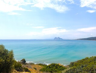 Fototapeta premium View from the Faro Punta Carbonera lighthouse near La Alcaidesa across the Mediterranean Sea to the Rock of Gibraltar