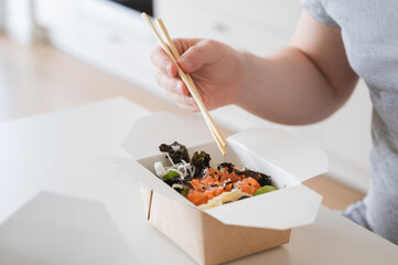 Salmon,avocado,seaweed poke bowl. Food delivery concept 