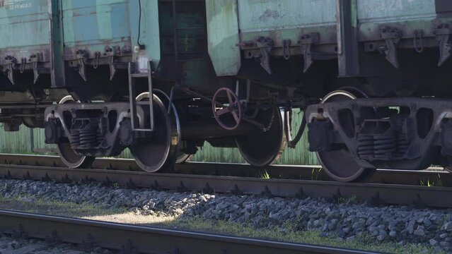 Freight train rides on the railroad. Close-up of the wheels. Logistic concept
