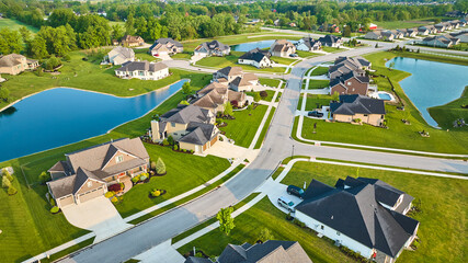 Rich expensive neighborhood aerial with mini mansions, high-end, million-dollar homes and ponds