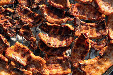 Cooking tasty tenderloin meat slices at bbq grill backyard. grilling on charcoal. steaks on the grill. Roasting meat on metal grid on hot charcoal. Grilling barbeque meat on the grill outdoors