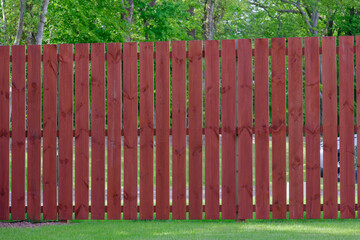 Wooden garden fence coated with medium oak colour paint