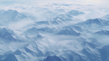 Aerial view of white snowy mountains with blue and cloudy sky