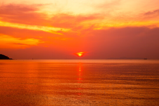 Orange sunset on the sea. The sun sets on the horizon. Travel and tourism.