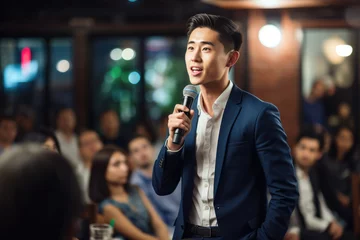 Foto op Plexiglas Younger Asian man engaged in a first-time public speaking event, filled with genuine emotion and feelings © MVProductions