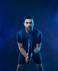 Padel tennis player. Man athlete with paddle tenis racket on black background.