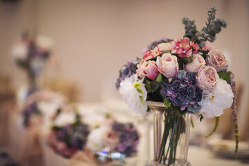 Beautiful Flower decoration of wedding tables. Banquet table setting and decoration. Cutlery on the table. Tables set for an event party. Luxury elegant table setting dinner in a restaurant.