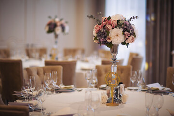Beautiful Flower decoration of wedding tables. Banquet table setting and decoration. Cutlery on the table. Tables set for an event party. Luxury elegant table setting dinner in a restaurant.