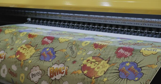 Industrial printing on paper, modern digital inkjet printer puts a picture on paper