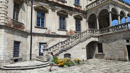 Old castle near Lvov. Podgoretsky castle. A woman in front of an old castle. Castles of Ukraine