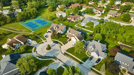 Cul-de-sac houses in neighborhood with tennis court amenity aerial