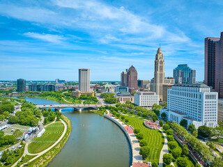 Aerial freshly mowed green park lawns on both sides of Scioto River downtown Columbus Ohio