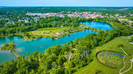 Distant city of Mount Vernon Ohio in aerial of large lake and island at Ariel Foundation Park trails