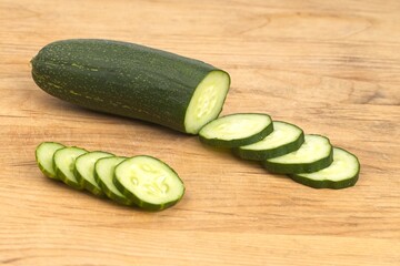 Cucumber slices on a cutting board.