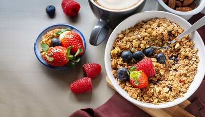 Breakfast table with granola, coffee and fresh berries