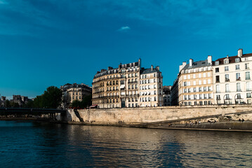 Fototapeta na wymiar Paris, France. April 24, 2022: City architecture with houses and Seine river view