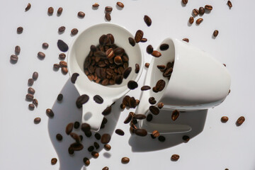  Coffee in white cups.Traditional morning drink. coffee mug.white ceramic cups and falling coffee beans.coffee levitation.Morning refreshing drink. 