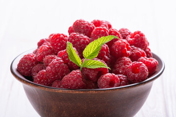 Raspberry in a basket .on wooden background