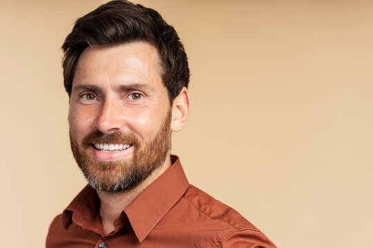 Portrait of handsome smiling middle aged man, handsome businessman looking at camera isolated on background, copy space. Happy bearded hipster after barbershop service