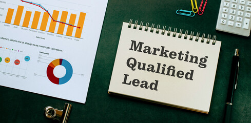 Naklejka na ściany i meble There is notebook with the word Marketing Qualified Lead. It is as an eye-catching image.