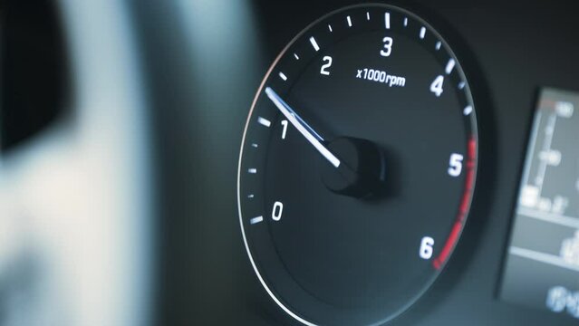Tachometer Moving With High Speed, Unrecognizable Driver Stepping On the Gas. Starting Engine of the Car and After Power Up. Indicator Moving Up Quickly. Close Up Real Time Inside of the Car.
