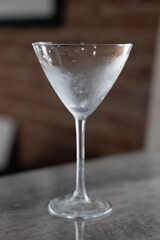 Chilled martini glass on reflective tile surface