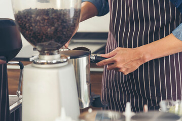 Close up hands coffee barista man make hot cup espresso shot from coffee machine. Cappuccino with milk in italian coffee shop cafe. Close up hands of barista use machine make black drinking hot cup