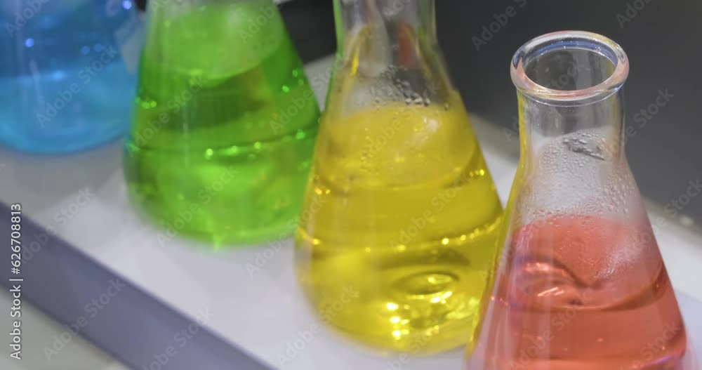 Aufkleber Liquid mixing in glass beaker for science experiment. Close up.  Analytical laboratory.  Mixing of the solution. Laboratory Mixer.