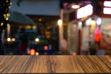 Empty dark wooden table in front of abstract blurred boken bankground of restaurant. Can used for display or montage your products. Mock up for space.
