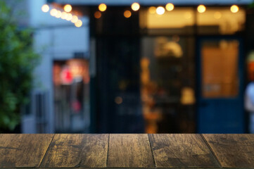 Empty dark wooden table in front of abstract blurred bokeh background of restaurant . can be used for display or montage your products.Mock up for space.