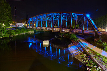 Amazing side shot of neon blue train bridge at night Mount Vernon Ohio walking bridge and river