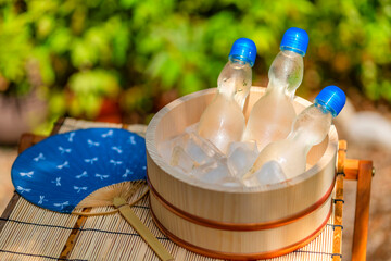 木陰で冷える瓶ラムネ / 夏休み・昭和レトロ・日本の夏の風物詩イメージ