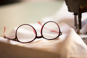 Retro eyeglasses on a sewing machine, close-up