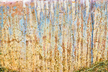 Concrete wall with streaks of blue and brown chemical erosion textured background asset