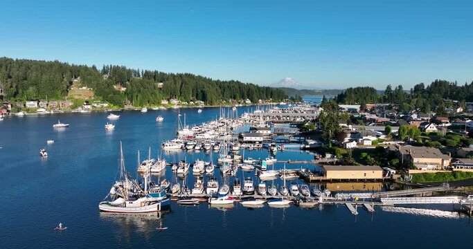 Panoramic view of the marina in Gig Harbor Washington with sail and fishing boats, mt rainier in the background