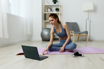 Fototapeta na wymiar lifestyle woman exercise video health laptop training lotus mat yoga home
