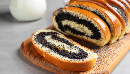 Cut poppy seed roll on table, closeup. Tasty cake