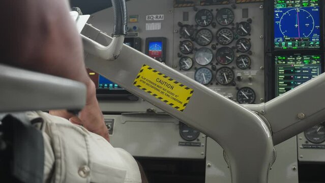 Steering wheel of seaplane with yellow caution label, control dashboard