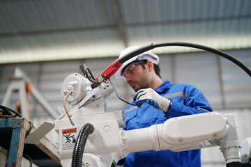 Multiracial industrial engineers working at automated AI robotic production factory, New industrial technology concept.