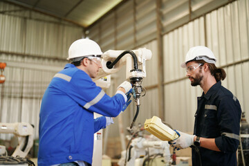 Multiracial industrial engineers working at automated AI robotic production factory, New industrial technology concept.