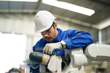 Multiracial industrial engineers working at automated AI robotic production factory, New industrial technology concept.