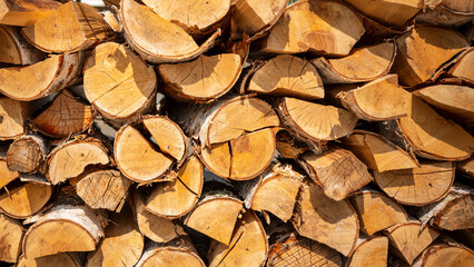 textured background of chopped firewood for kindling and heating the house, a woodpile with stacked firewood. Banner for design.