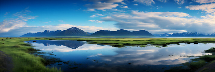 Fototapeta na wymiar beautiful panoramic view of the lake with mountains reflection and blue cloudy sky